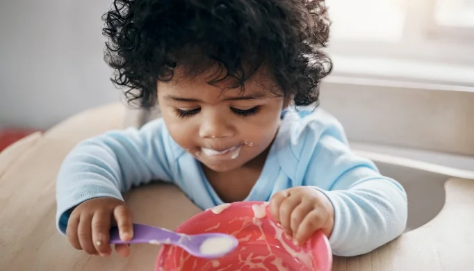toddler feeding themself