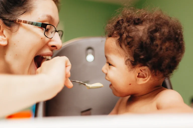 mother feeding toddler